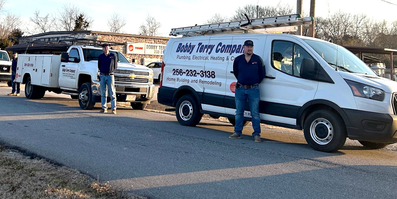Bobby Terry Company service van and truck with three workers standing outside in a parking lot